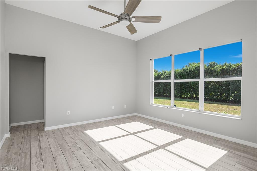 2022 Fairmont Lane Naples, FL 34120 - Photo 10 of 33 a view of an empty room with a window and wooden floor