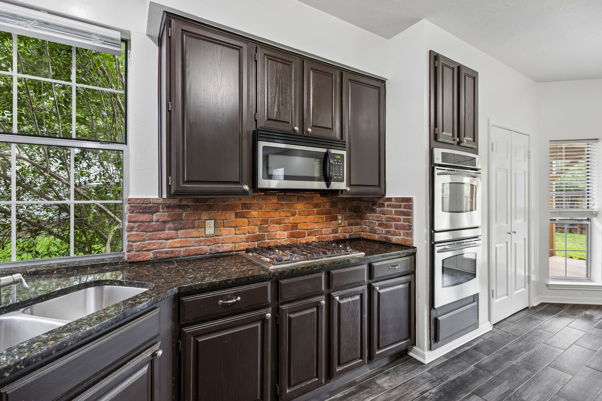 10400 O'Rourk Lane Austin, TX 78739 - Photo 5 of 33 a kitchen with granite countertop stainless steel appliances and wooden cabinets