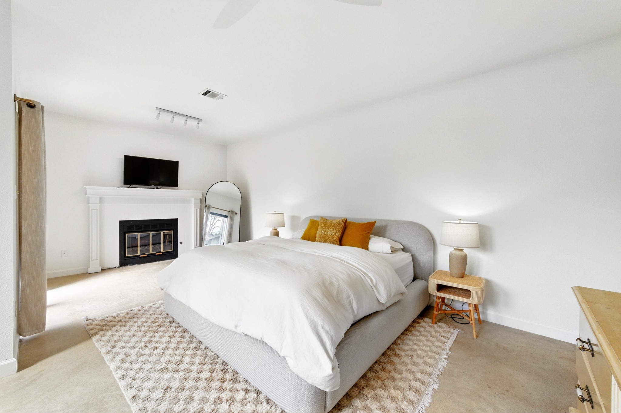 5807 Convict Hill Road Austin, TX 78749 - Photo 15 of 27 The spacious primary suite features a cozy fireplace and neutral tones, creating a relaxing retreat. Clean lines and serene finishes complete the look.