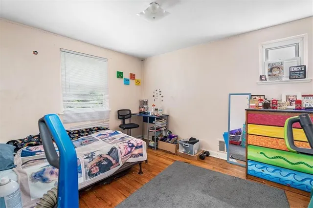 a bedroom with bed and a window