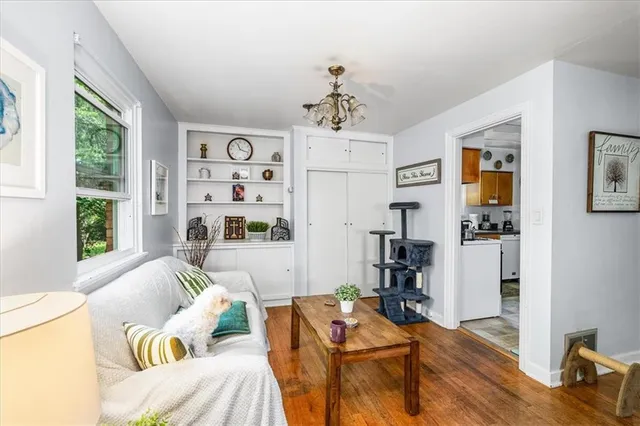 a living room with furniture and wooden floor