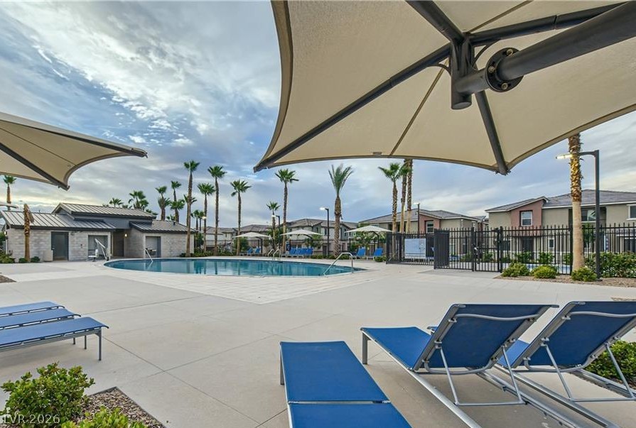 12110 Midnight Pine Road, Unit 3 Las Vegas, NV 89183 - Photo 1 of 13 An inviting resort-style pool with shaded lounging areas awaits in this vibrant community setting.