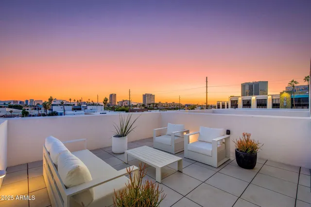 a terrace with outdoor seating and city view