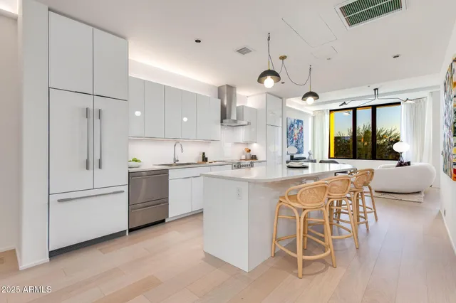 a kitchen with stainless steel appliances kitchen island granite countertop a sink and cabinets