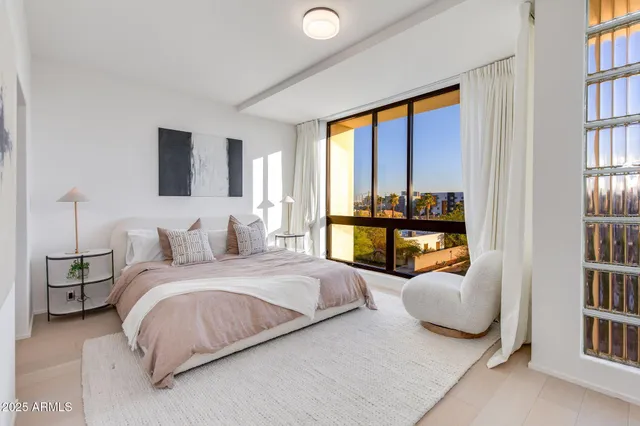 a bedroom with a bed and a book shelf