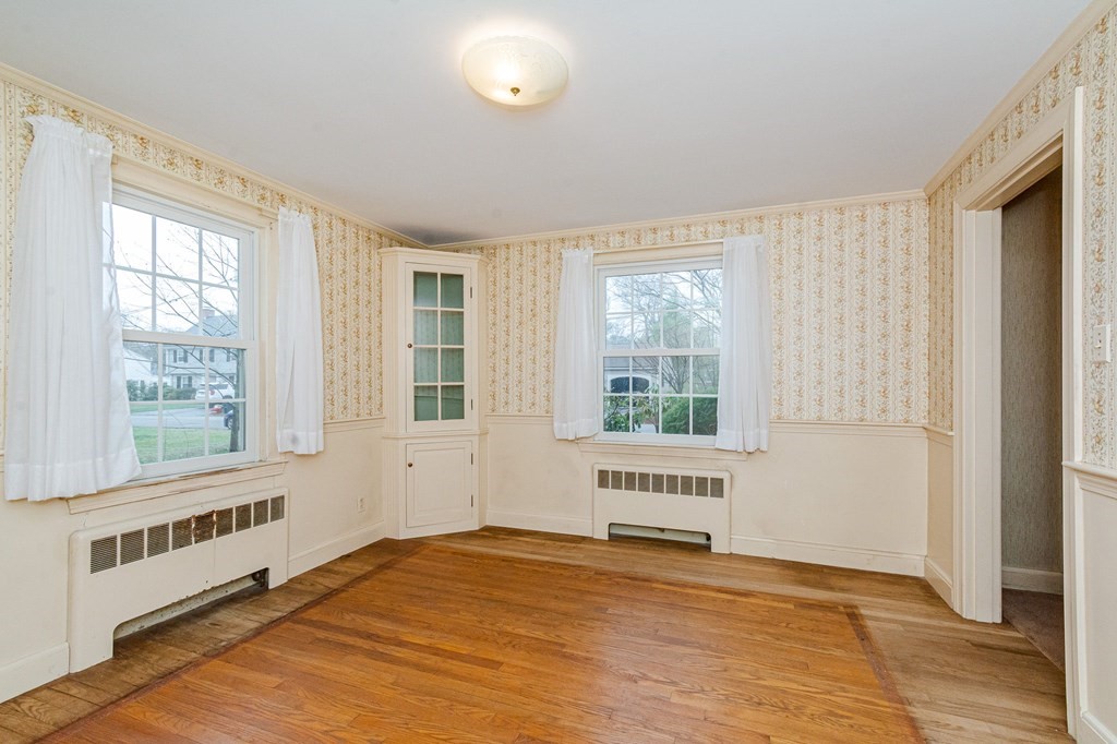 50 Oak Ridge Road Reading, MA 01867 - Photo 13 of 36 a view of an empty room with a window and wooden floor