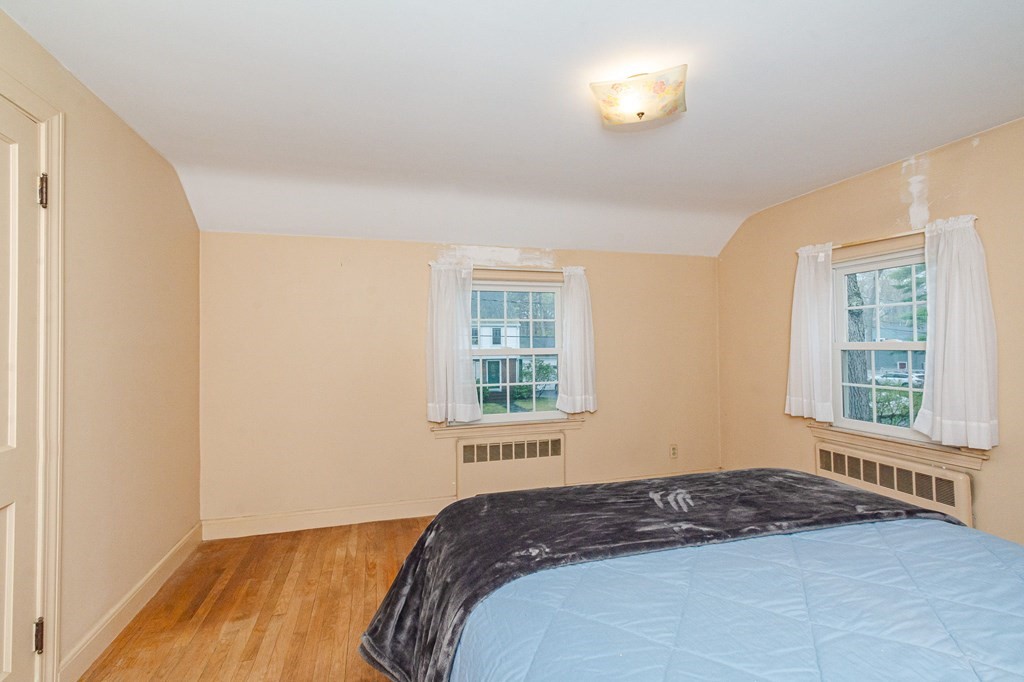 50 Oak Ridge Road Reading, MA 01867 - Photo 18 of 36 a bedroom with a bed and a window