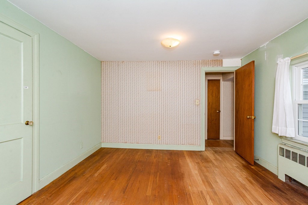 50 Oak Ridge Road Reading, MA 01867 - Photo 23 of 36 an empty room with wooden floor and windows