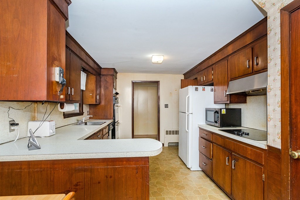 50 Oak Ridge Road Reading, MA 01867 - Photo 4 of 36 a kitchen with stainless steel appliances a sink stove and refrigerator