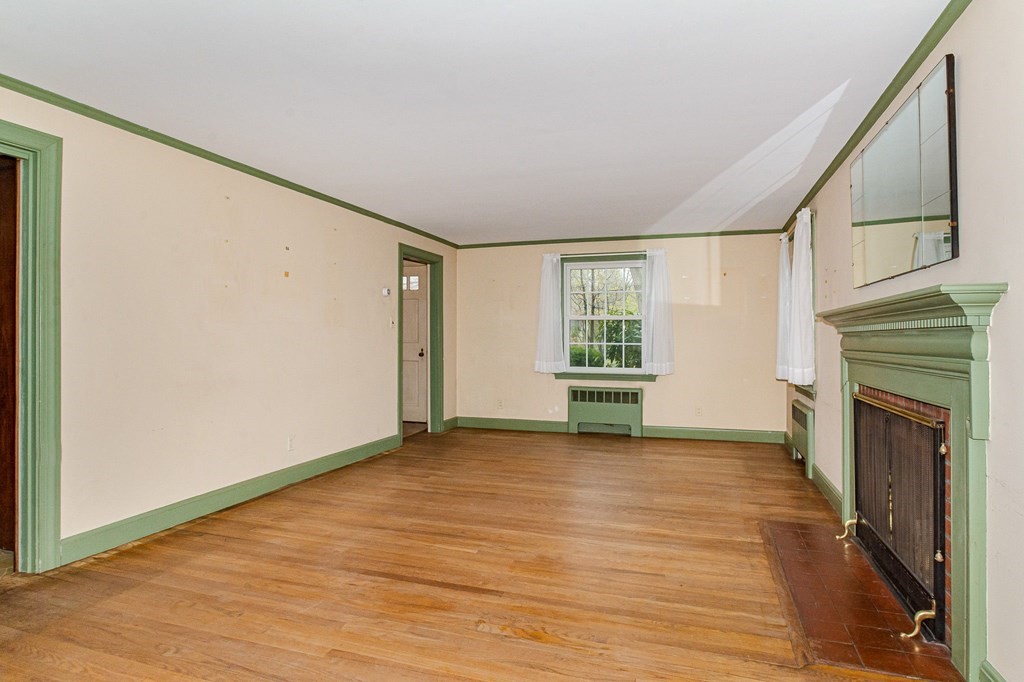 50 Oak Ridge Road Reading, MA 01867 - Photo 8 of 36 a view of an empty room with a window and fireplace