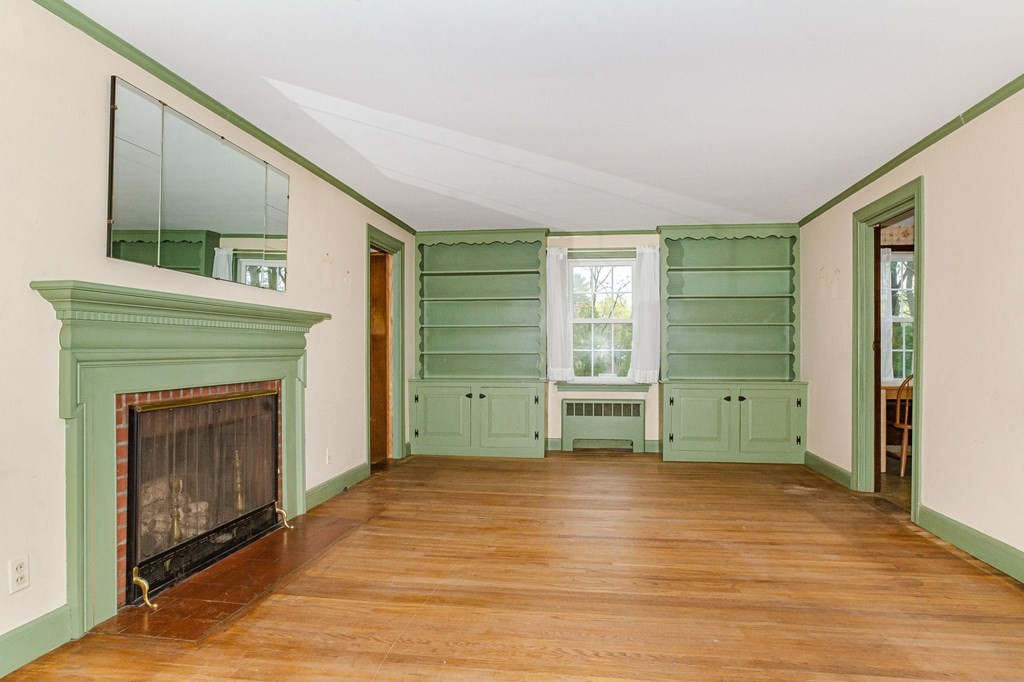 50 Oak Ridge Road Reading, MA 01867 - Photo 9 of 36 a view of an empty room with a fireplace and a window