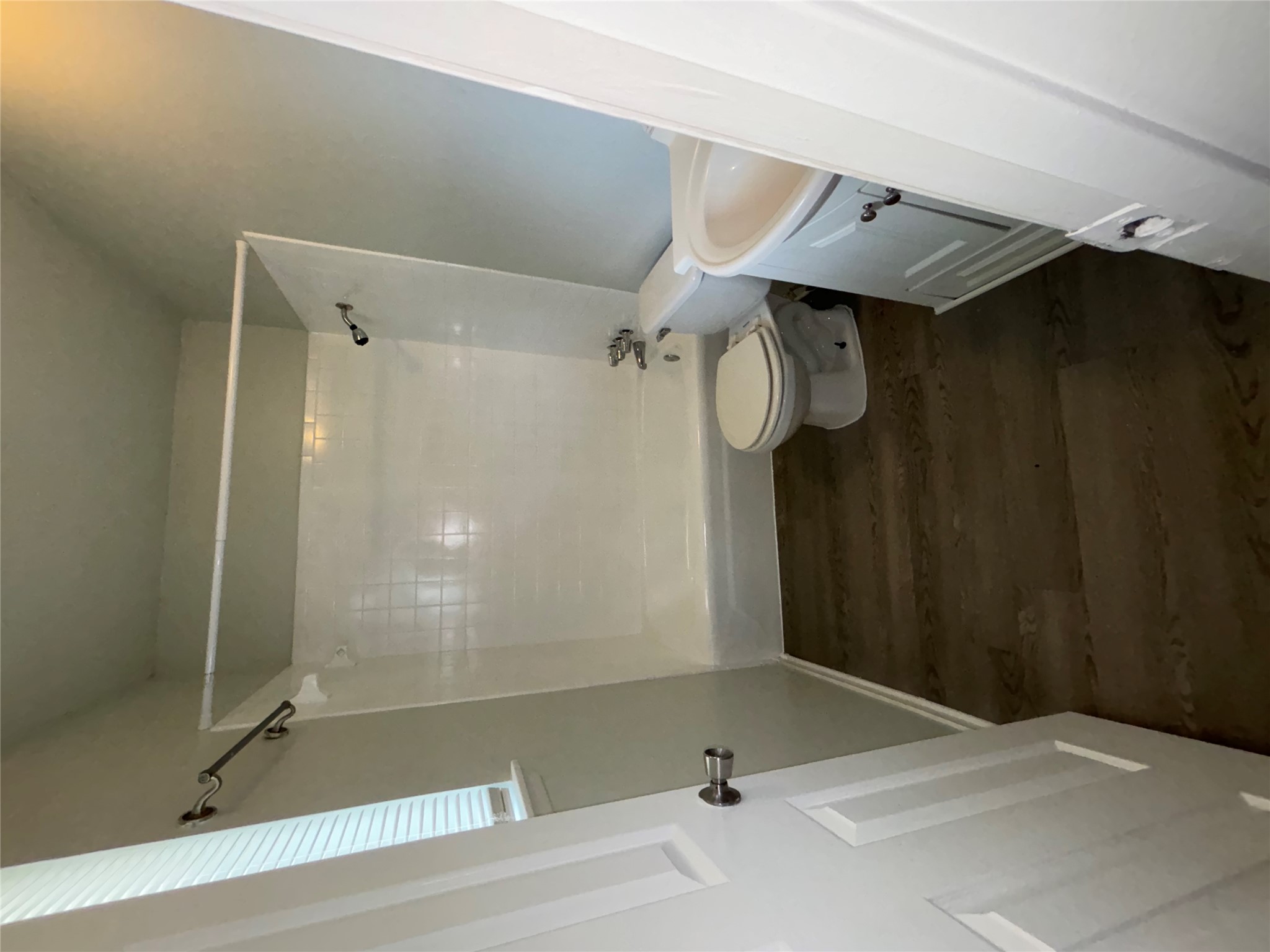 5905 Cherry Loop Austin, TX 78745 - Photo 12 of 13 Functional full bathroom featuring rich wood-look flooring and a clean tub-shower combination.