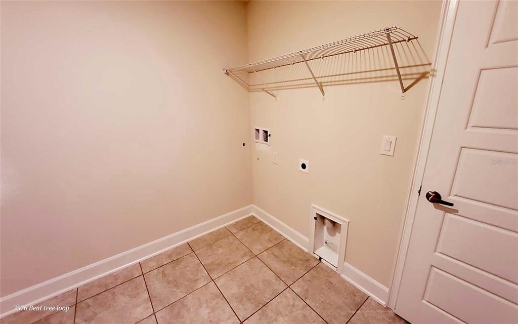 7576 Bent Tree Loop St. Cloud, FL 34773 - Photo 13 of 18 a view of a room with racks on the wall