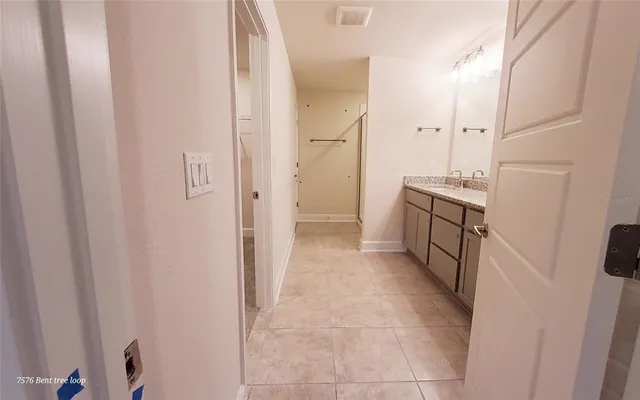 a bathroom with a granite countertop sink a mirror and a shower