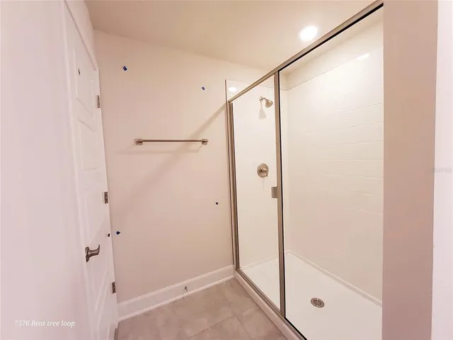 a bathroom with a glass shower door