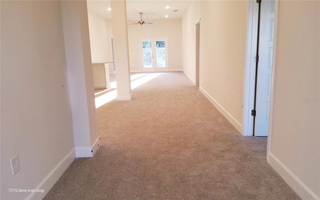 7576 Bent Tree Loop St. Cloud, FL 34773 - Photo 3 of 18 a view of a hallway with a bathroom