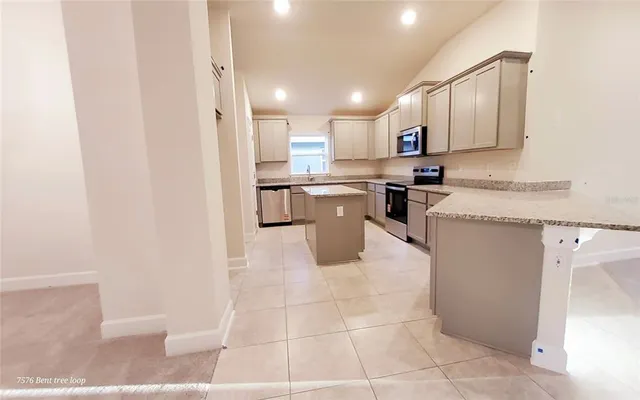 a kitchen with stainless steel appliances granite countertop a sink and cabinets