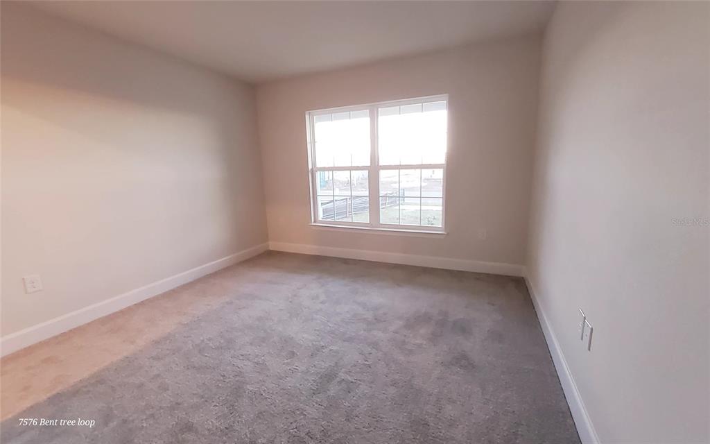 7576 Bent Tree Loop St. Cloud, FL 34773 - Photo 8 of 18 an empty room with a window