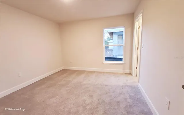 a view of an empty room and a window