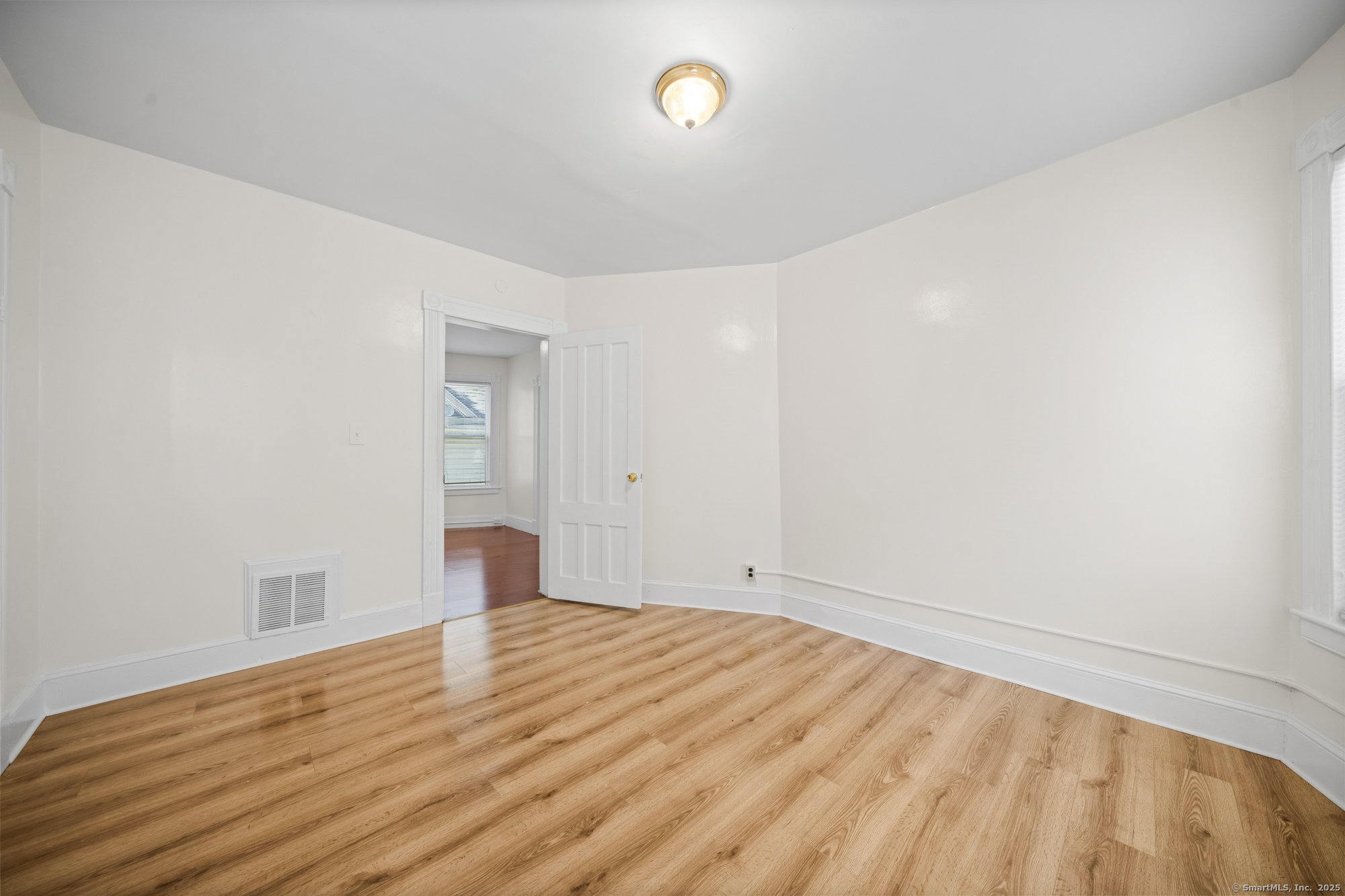 217 Woodlawn Terrace Waterbury, CT 06710 - Photo 2 of 9 a view of empty room with wooden floor