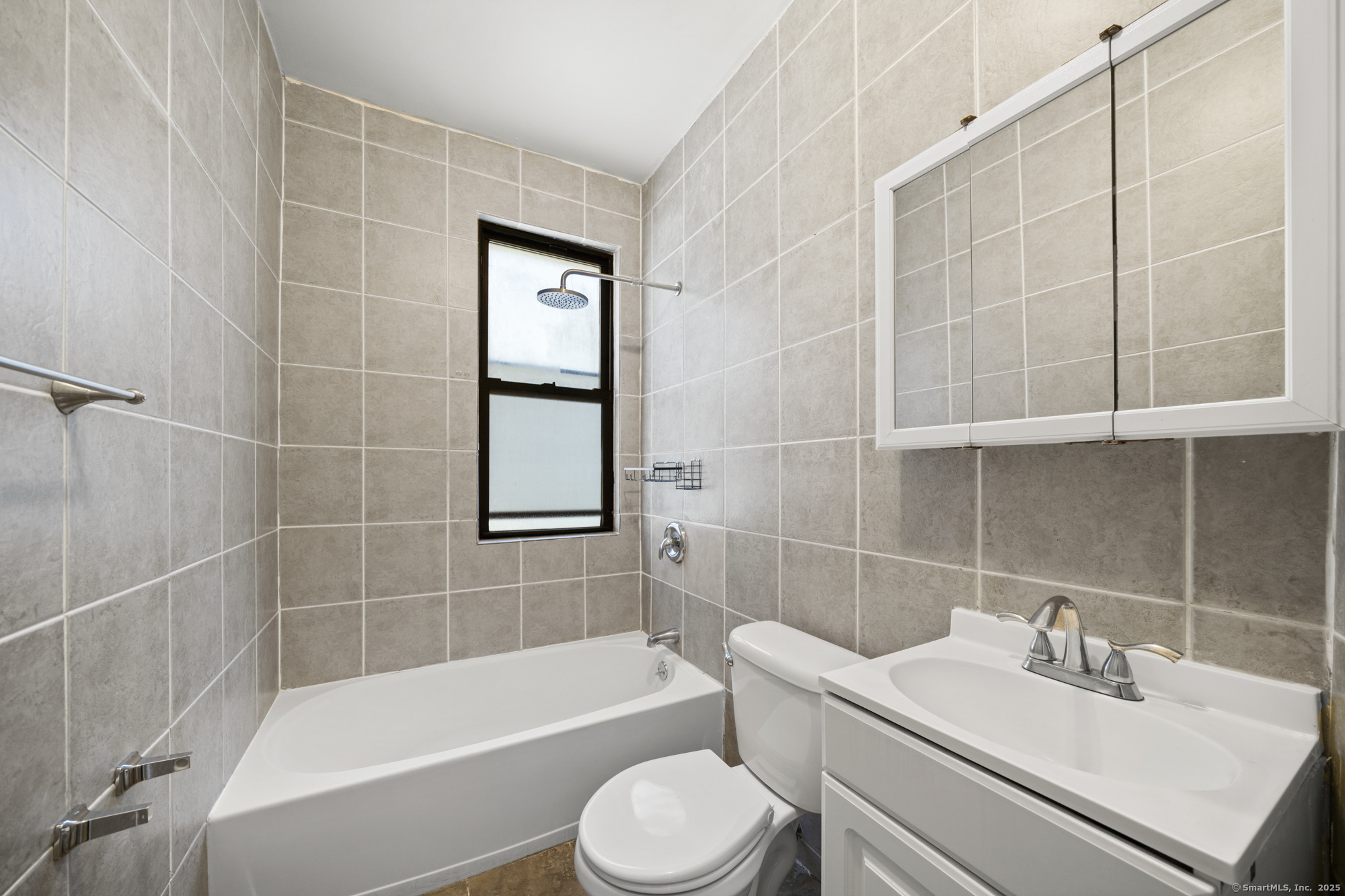 217 Woodlawn Terrace Waterbury, CT 06710 - Photo 4 of 9 a bathroom with a sink toilet and shower