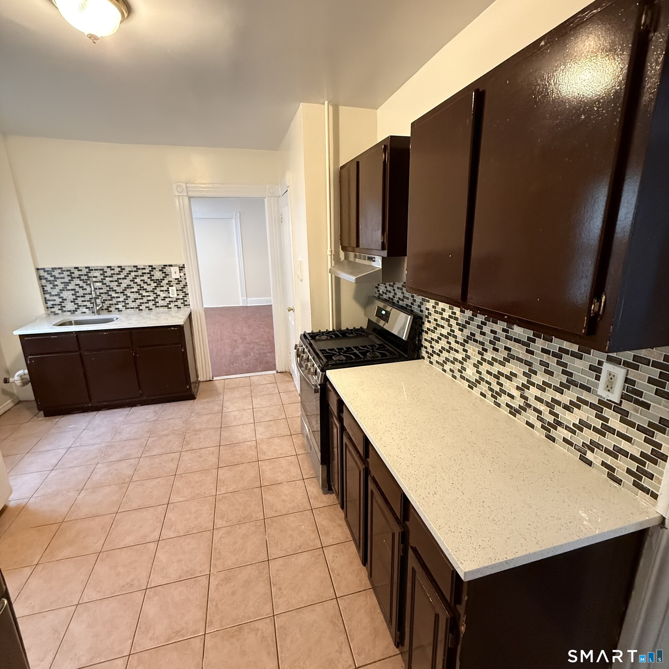 217 Woodlawn Terrace Waterbury, CT 06710 - Photo 7 of 9 a bathroom with a sink and a mirror
