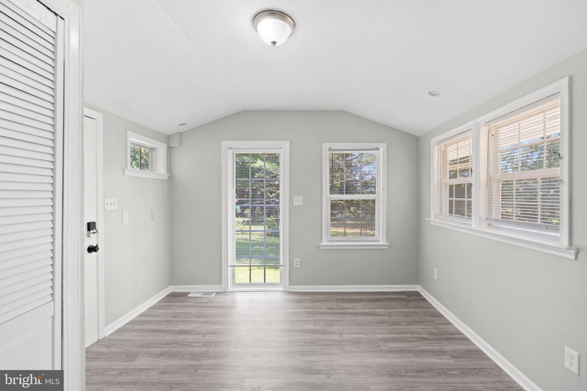 8405 Shirley Road Spotsylvania, VA 22551 - Photo 15 of 42 a view of an empty room with wooden floor and a window