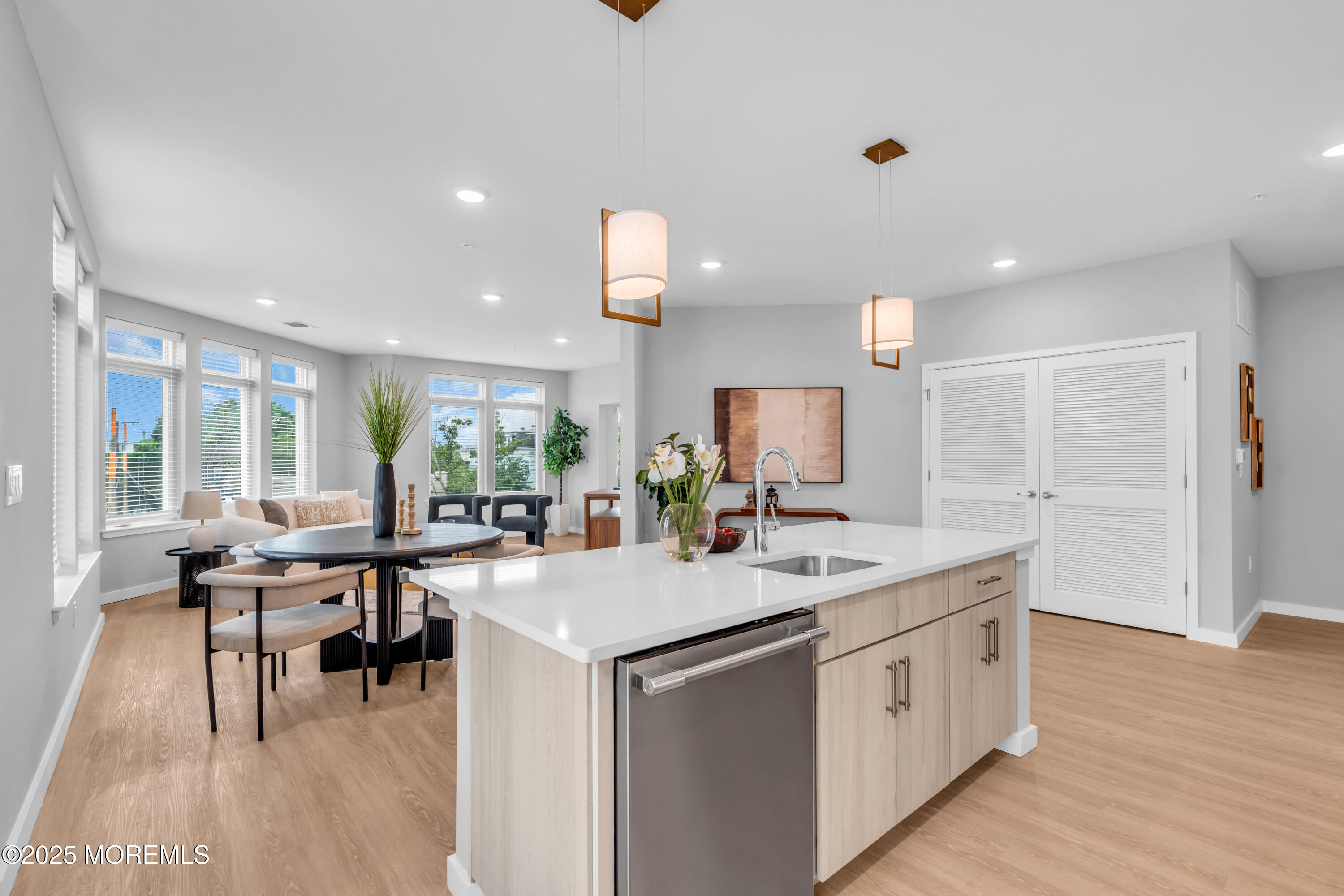 120 Monmouth Street, Unit DAHLIA306 Red Bank, NJ 07701 - Photo 9 of 37 a room with stainless steel appliances kitchen island granite countertop a sink and dishwasher with wooden floor
