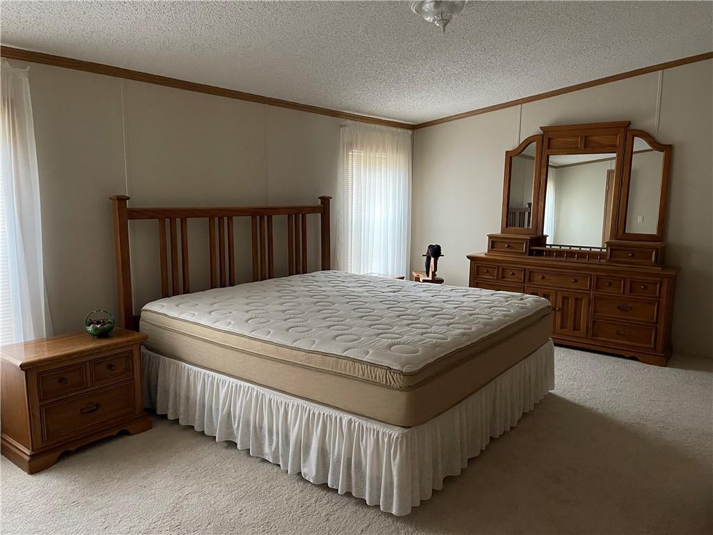 168 Big Rock Road Berlin, PA 15530 - Photo 13 of 25 a spacious bedroom with a bed and a dresser with a tv in it