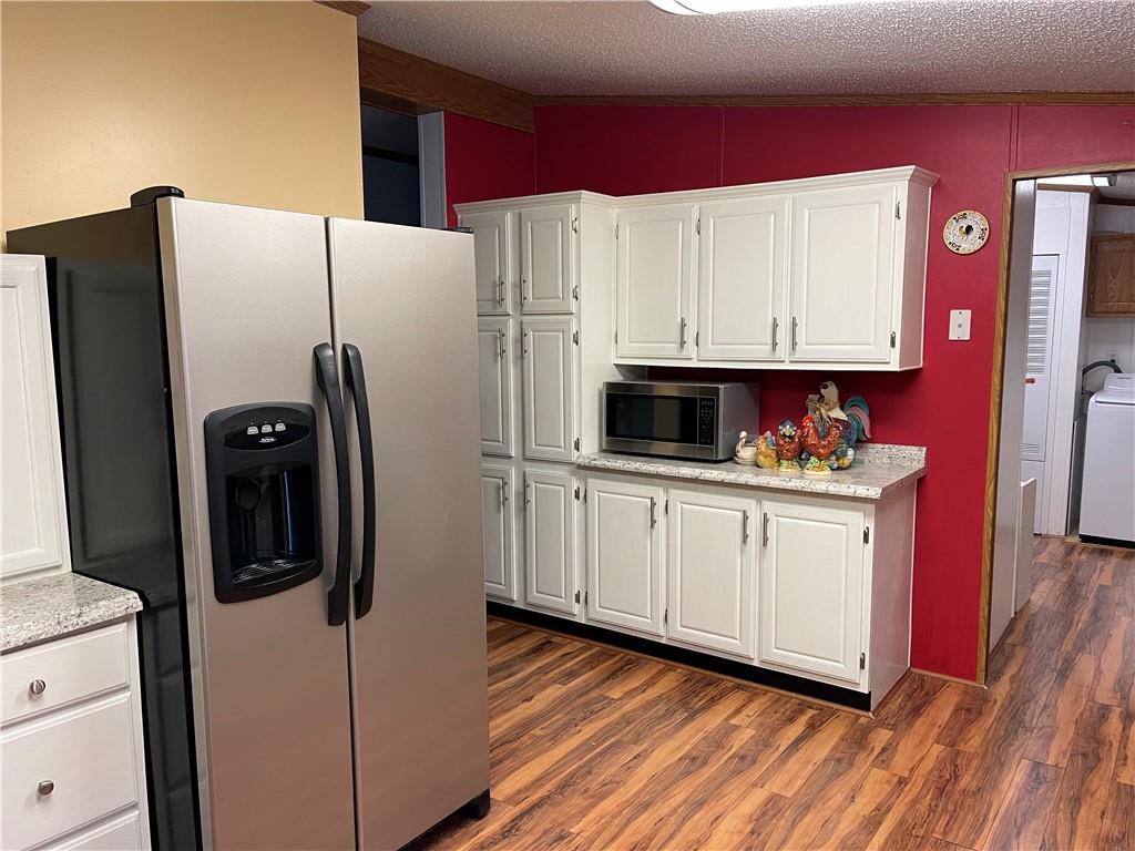 168 Big Rock Road Berlin, PA 15530 - Photo 8 of 25 a kitchen with stainless steel appliances a refrigerator a sink and wooden floor