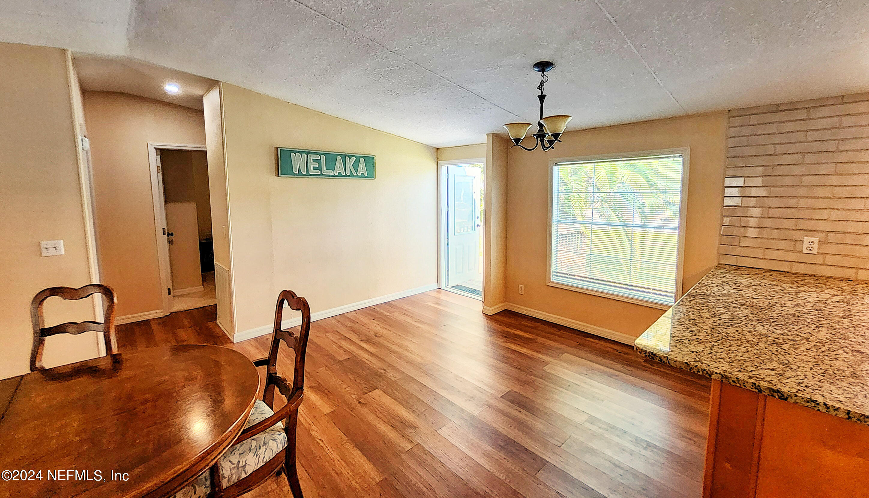 44 Scott Welaka, FL 32193 - Photo 15 of 35 a view of a dining room with furniture window and wooden floor