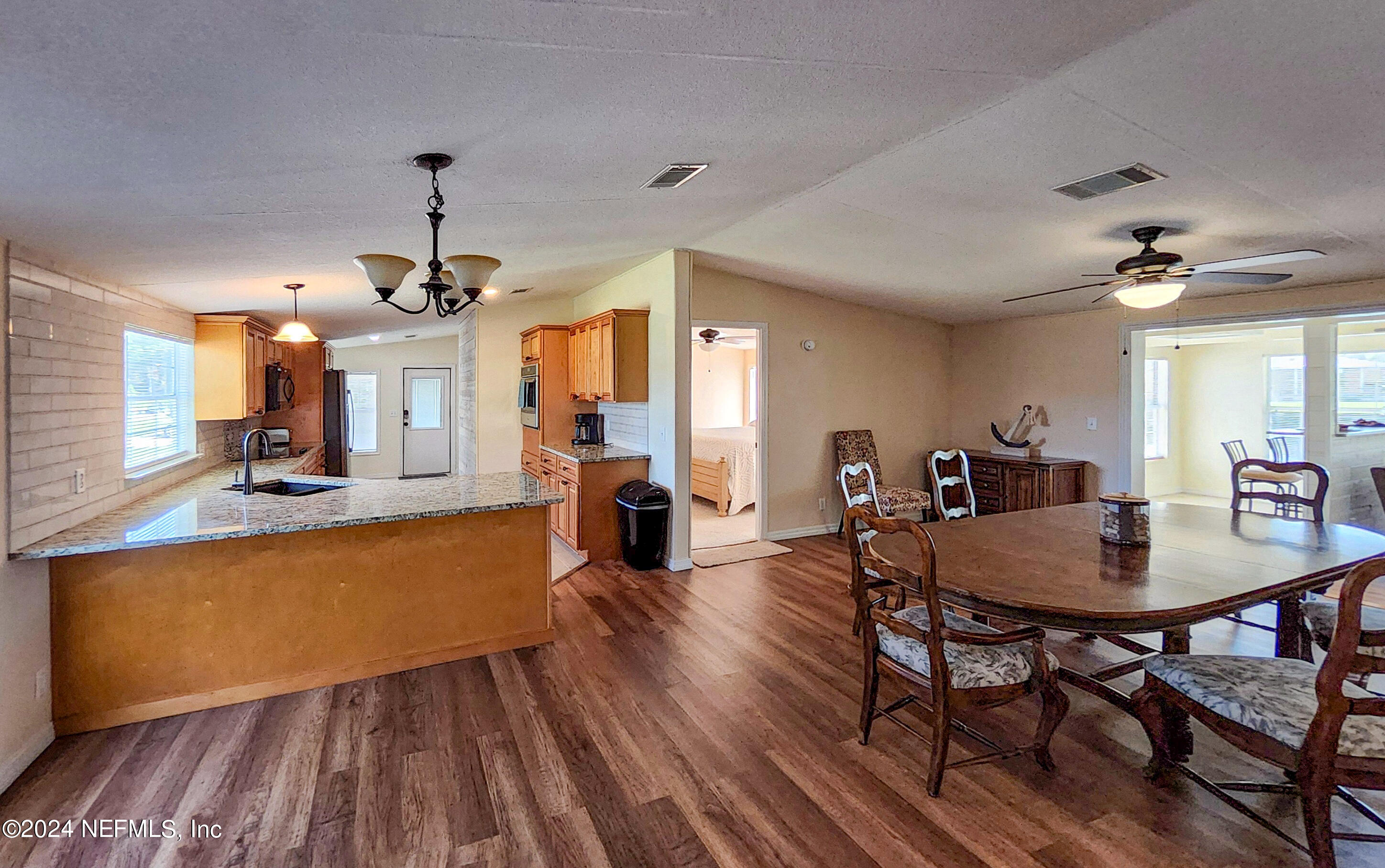 44 Scott Welaka, FL 32193 - Photo 16 of 35 a view of a dining room with furniture and wooden floor