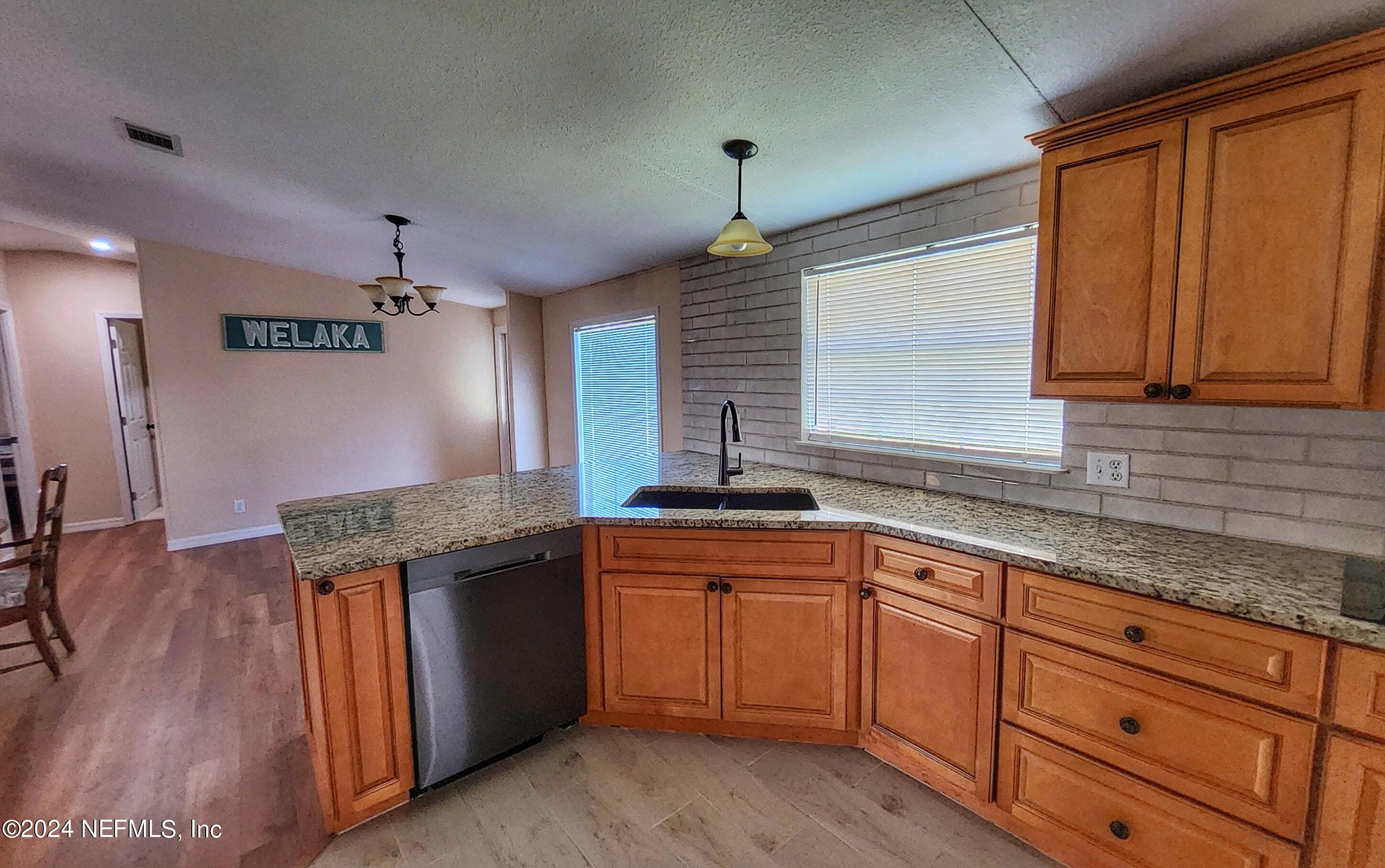 44 Scott Welaka, FL 32193 - Photo 20 of 35 a kitchen with granite countertop cabinets stainless steel appliances a sink and a window