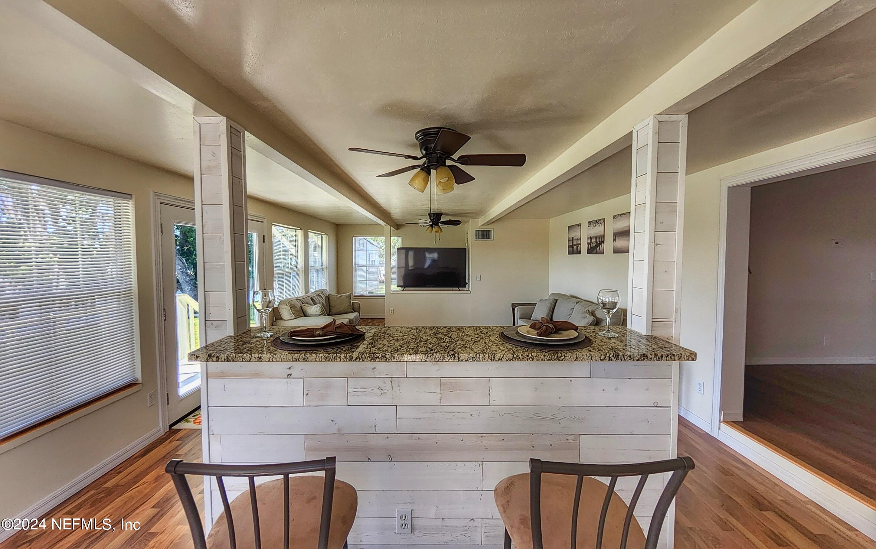 44 Scott Welaka, FL 32193 - Photo 26 of 35 a kitchen with granite countertop a table and chairs in it