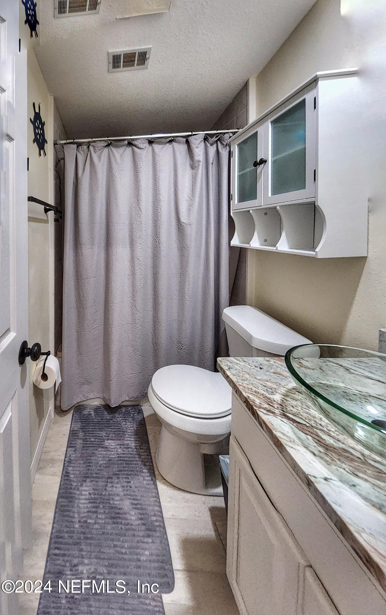 44 Scott Welaka, FL 32193 - Photo 31 of 35 a bathroom with a granite countertop sink toilet and shower