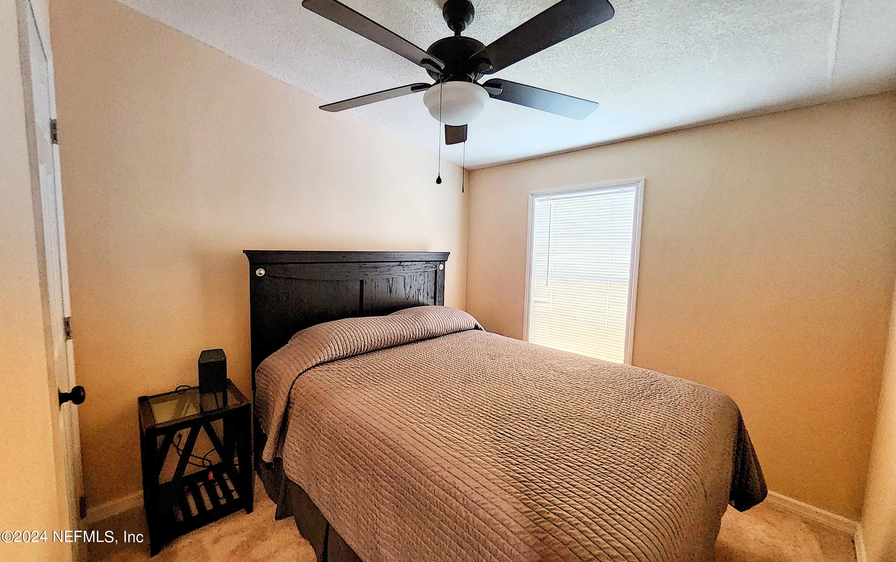 44 Scott Welaka, FL 32193 - Photo 33 of 35 a bedroom with a bed and a ceiling fan