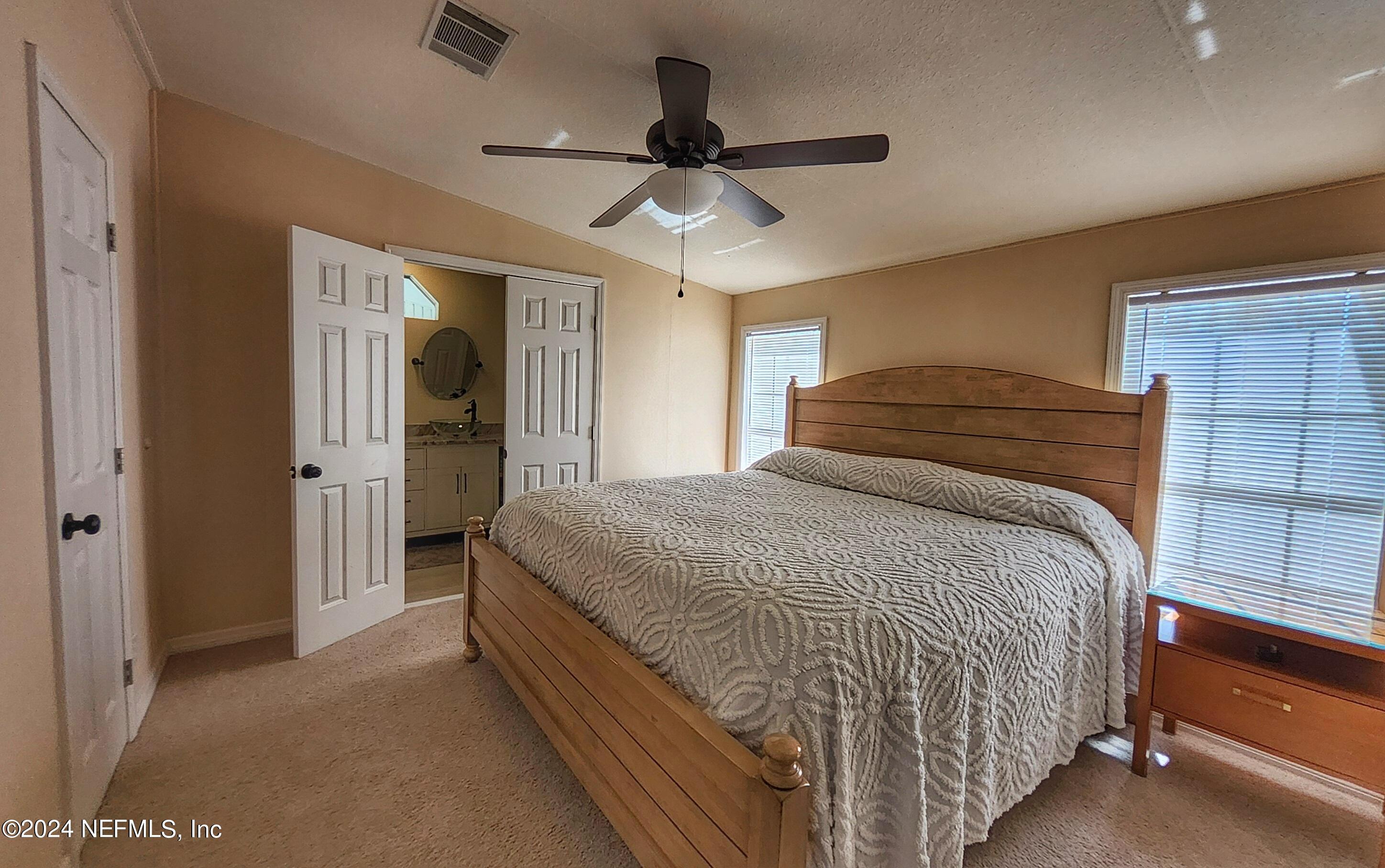 44 Scott Welaka, FL 32193 - Photo 34 of 35 a bedroom with a bed and a ceiling fan