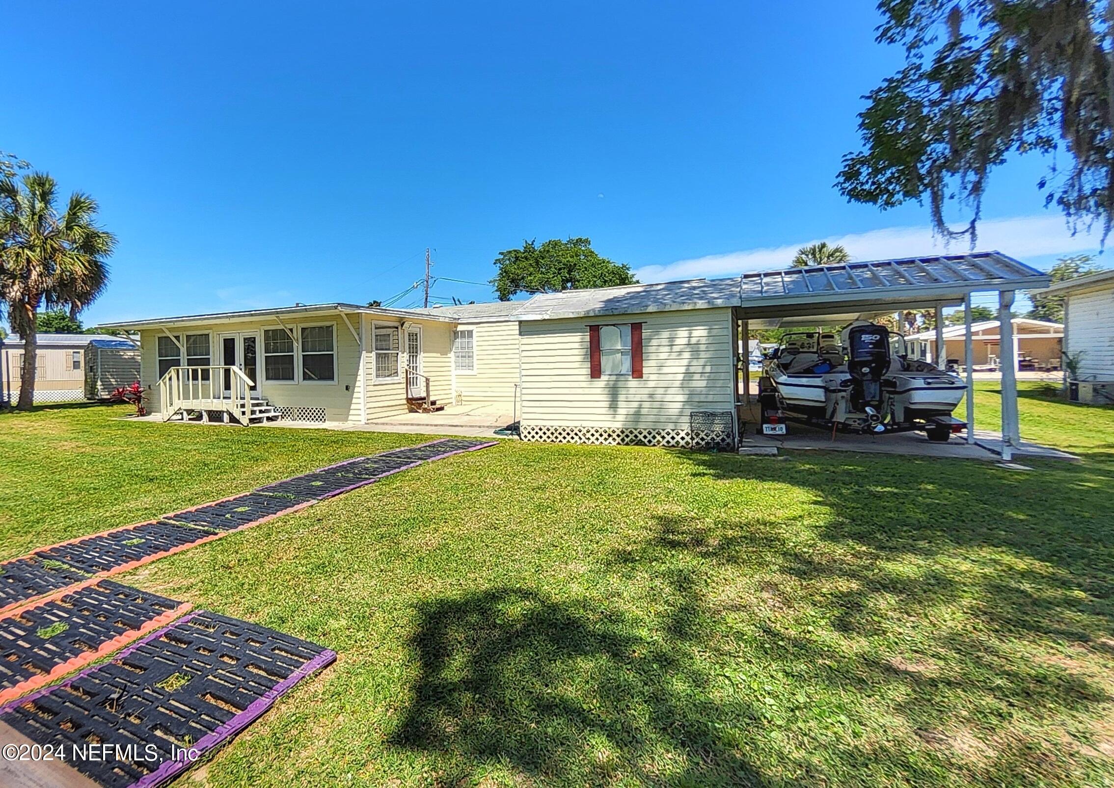 44 Scott Welaka, FL 32193 - Photo 8 of 35 a front view of a house with a yard table and chairs
