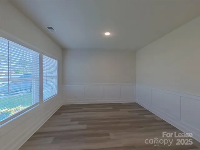 a view of a room with wooden floor and window