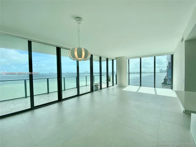 a view of an empty room with windows