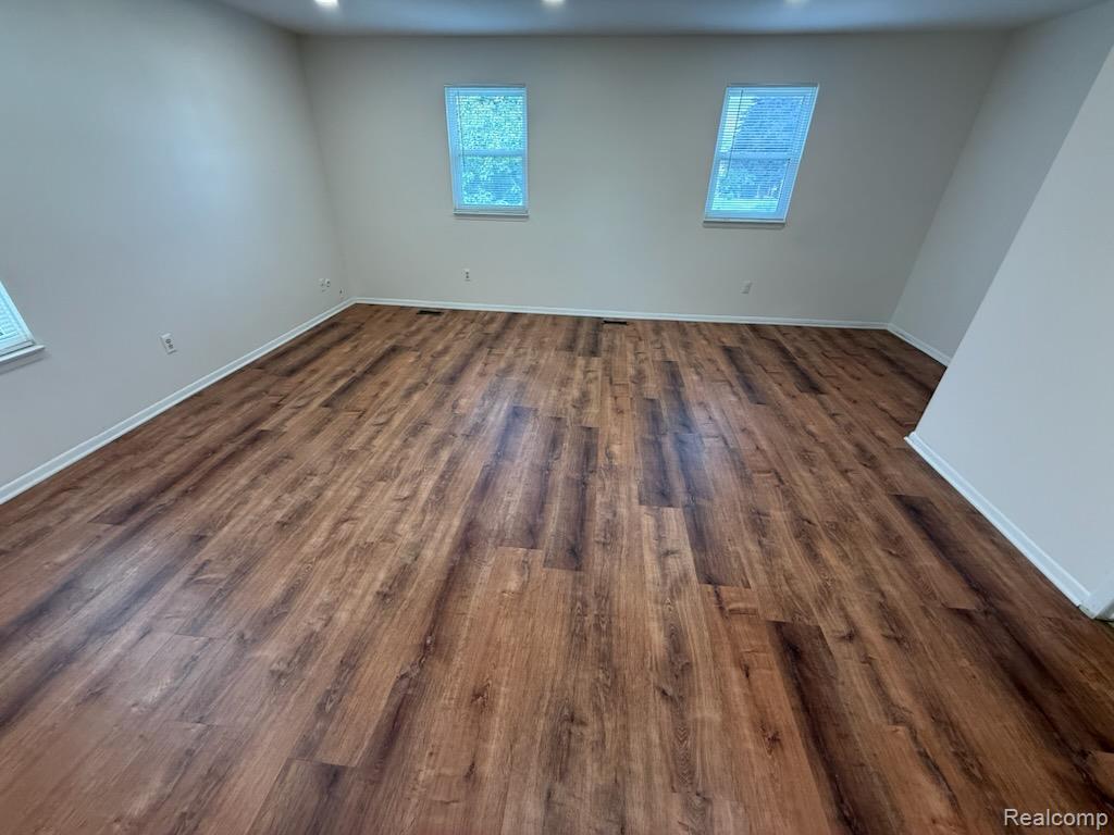 28144 Yorktown Road Farmington, MI 48331 - Photo 10 of 25 Spacious interior featuring wood-finish flooring, white baseboards, and neutral wall paint