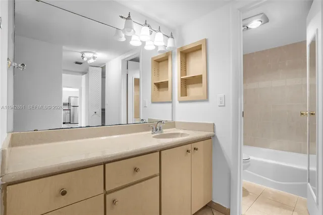 a bathroom with a granite countertop sink mirror and double