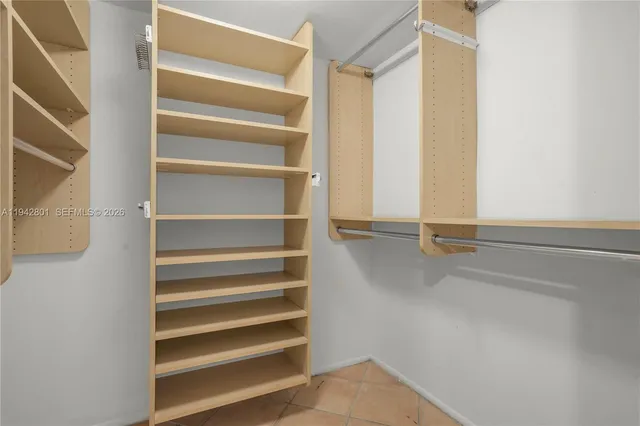 a view of walk in closet with empty racks