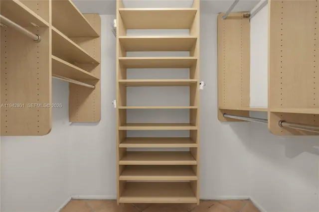 a view of walk in closet with empty racks