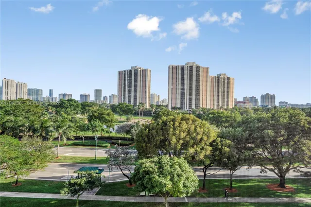 a view of a city with tall buildings and a big yard