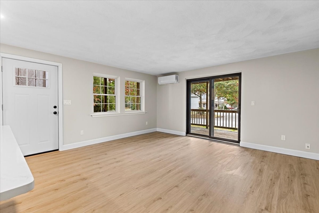 35 Ashumet Road, Unit 11B Mashpee, MA 02649 - Photo 15 of 24 an empty room with wooden floor and windows