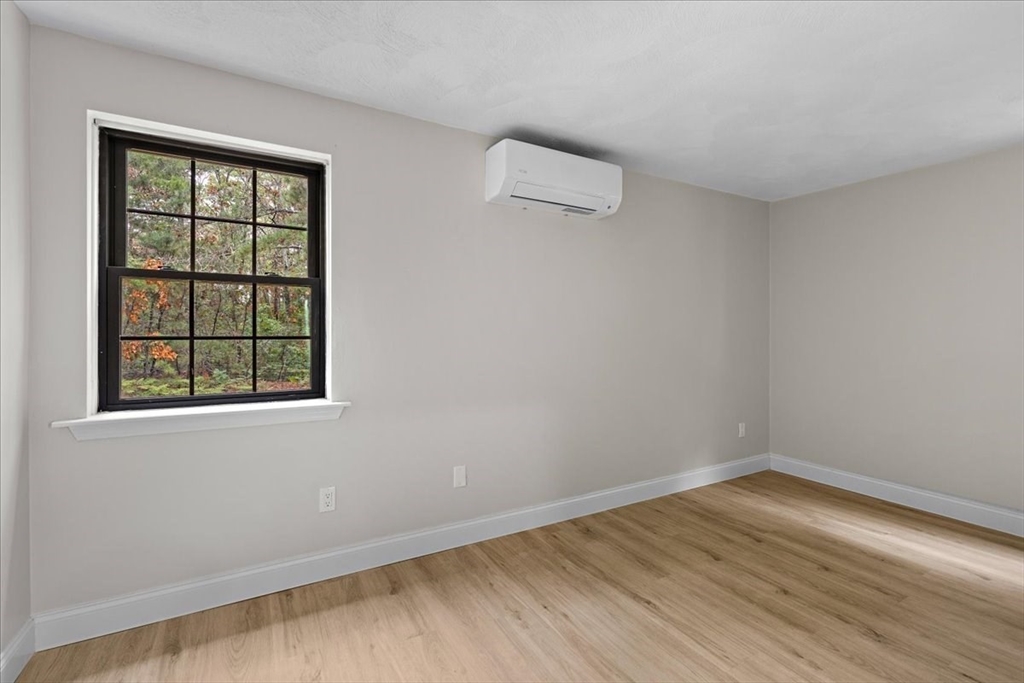 35 Ashumet Road, Unit 11B Mashpee, MA 02649 - Photo 17 of 24 an empty room with wooden floor and windows