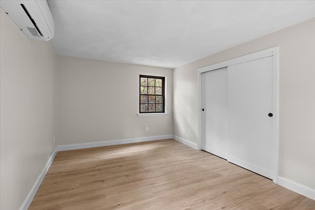 35 Ashumet Road, Unit 11B Mashpee, MA 02649 - Photo 19 of 24 a view of an empty room with wooden floor and windows