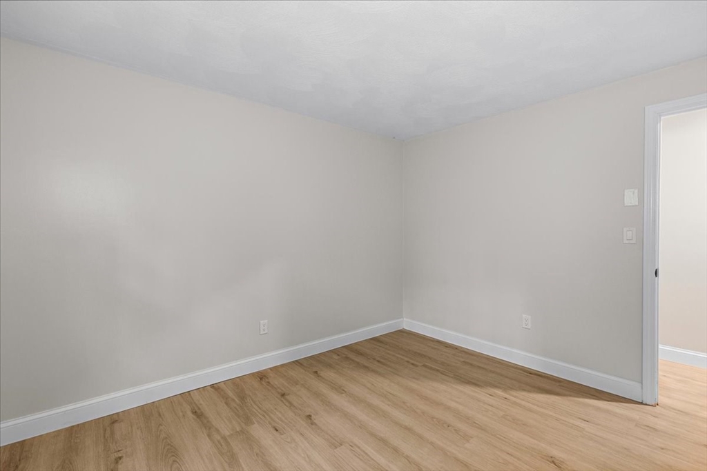 35 Ashumet Road, Unit 11B Mashpee, MA 02649 - Photo 24 of 24 a view of an empty room with wooden floor