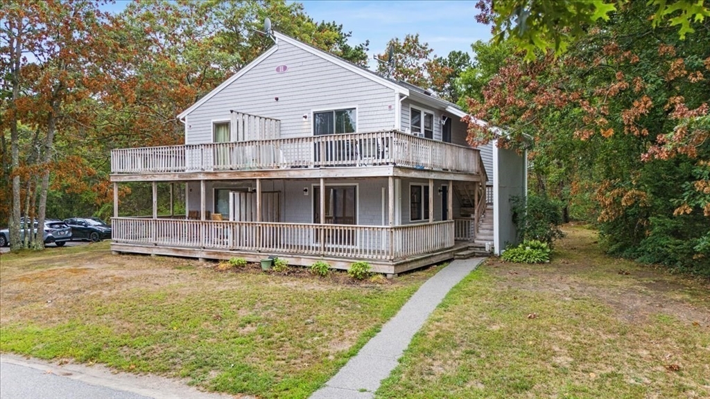 35 Ashumet Road, Unit 11B Mashpee, MA 02649 - Photo 3 of 24 a view of house with yard and sitting area
